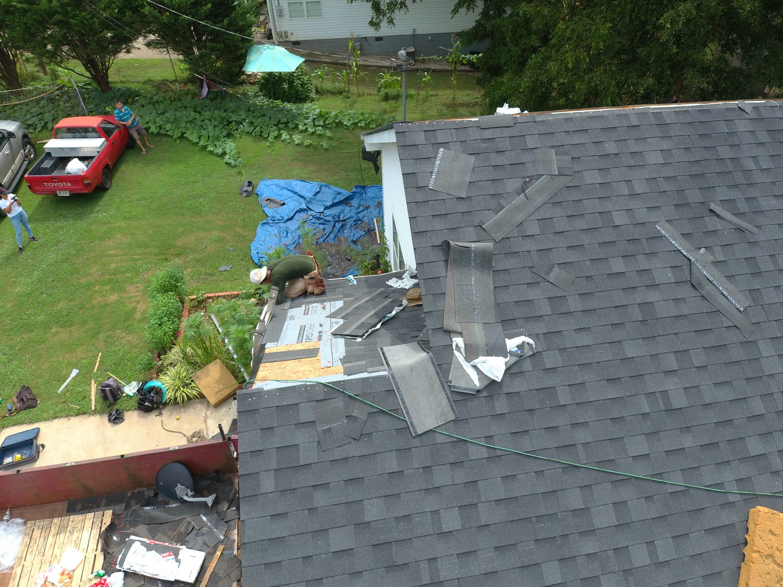 The Smart Company GA — aerial view of crew performing shingle tear-off and reroof on a suburban home